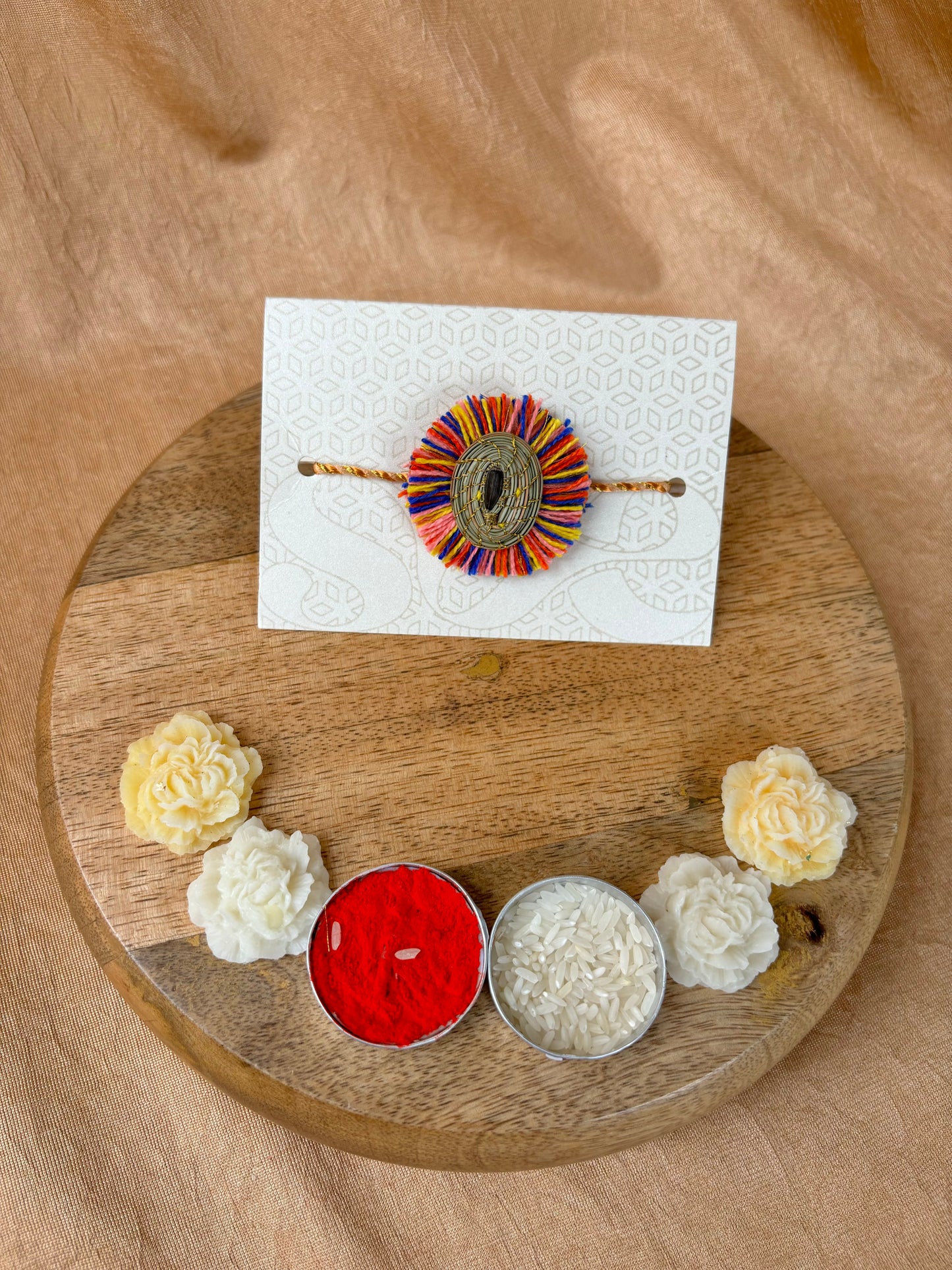 SOE Plantable Pine Needle Rakhi: GULMOHAR with sunflower seed (with rice & tikka)