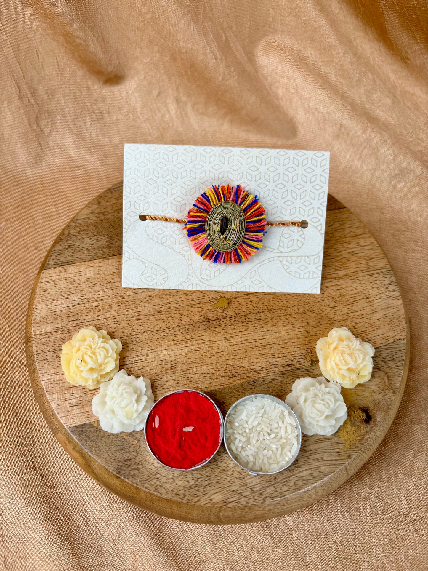 SOE Plantable Pine Needle Rakhi: GULMOHAR with sunflower seed (with rice & tikka)